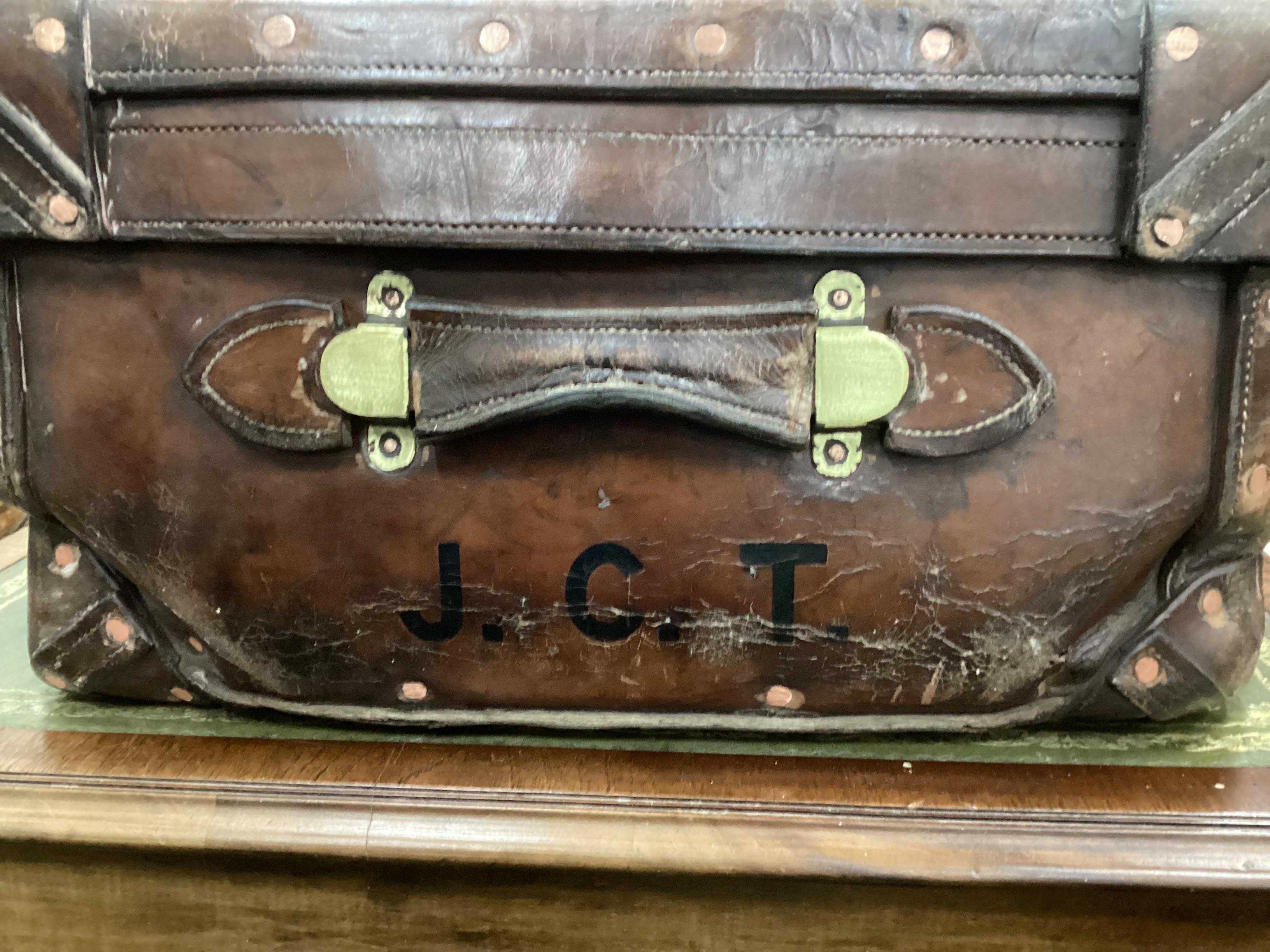 A Victorian leather brass and copper studded travelling trunk, width 86cm, depth 55cm, height 30cm